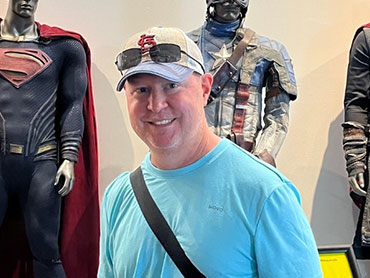Stephen Allbright standing wearing a blue shirt and hat.
