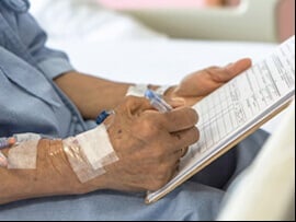 Patient signing an advanced directive.