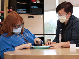therapist working with a patient with a neurological condition