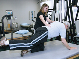 therapist working with patient doing exercises