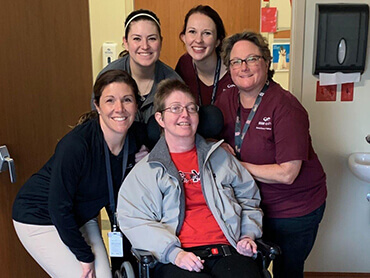 Patient Christina Gass poses with 4 of her physical therapists.
