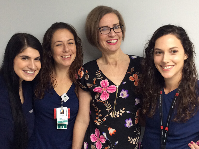 Patient Fiona Moree poses with 3 of her physical therapists.