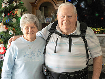 Patient Paul Simon standing beside his wife.
