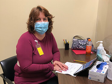 Patient Vonda Mathis working at a computer.