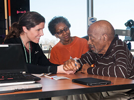 Therapist working with a patient and his wife.