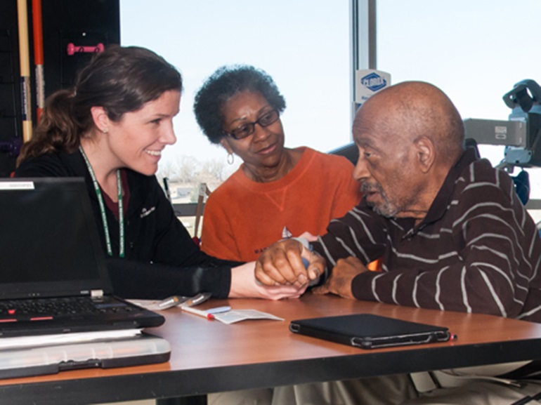 Therapist working with a patient and his wife.